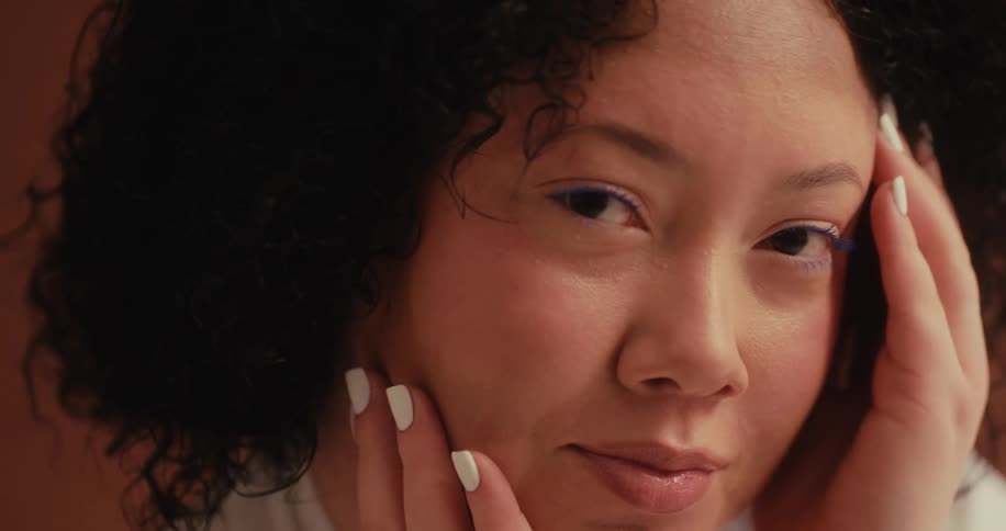 Portrait of a curly haired woman with happy facial expression