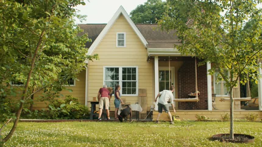 A family are working in the yard together