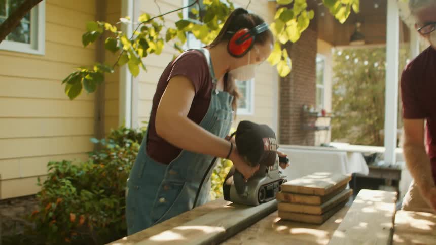 Women are sanding boards of wood