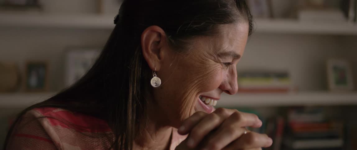 A woman is laughing and talking