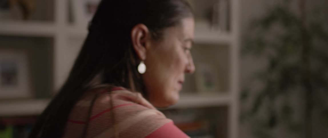 A woman reaches over for something