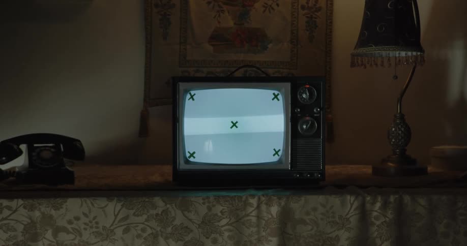 The television is on in the dark room