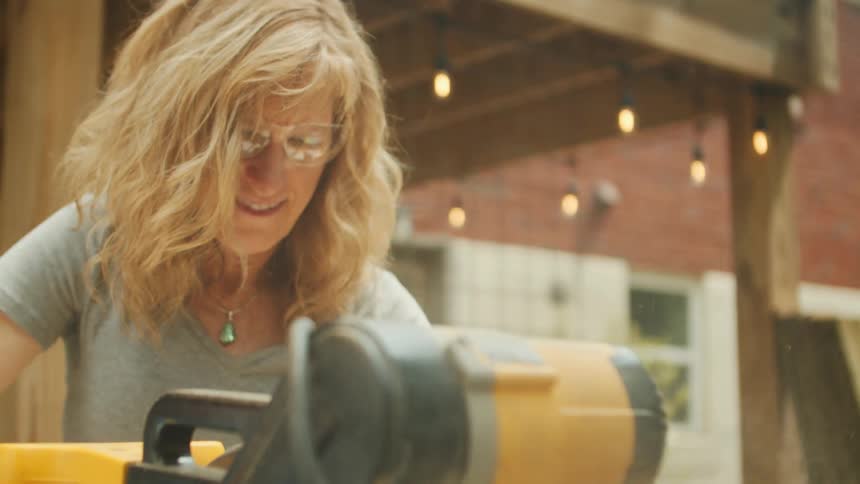 Blonde woman handling a cutting saw