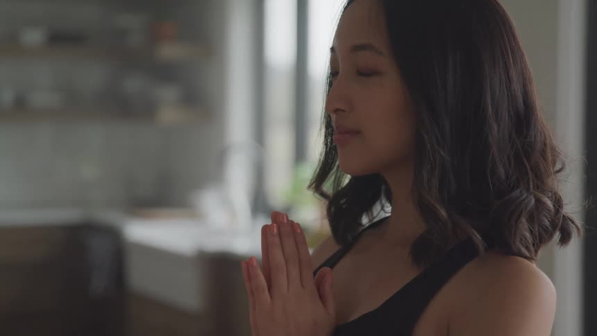 A woman is praying at home