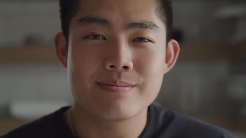 A man turns and smiles at the camera
