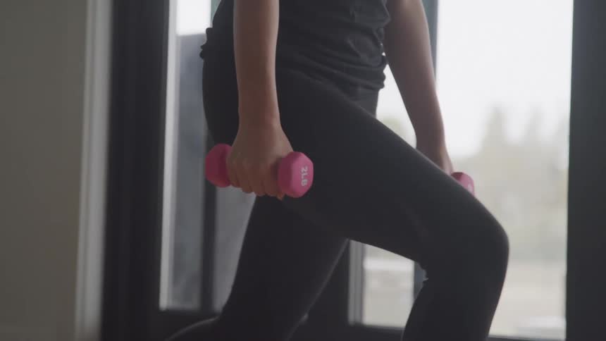 Legs of a person doing weighted squats
