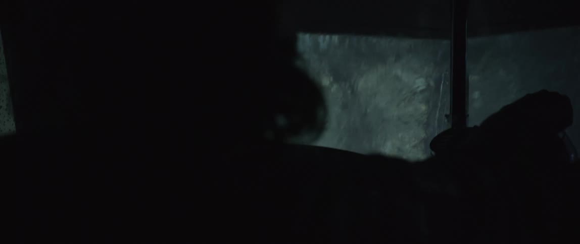 A person drives a car in the rain