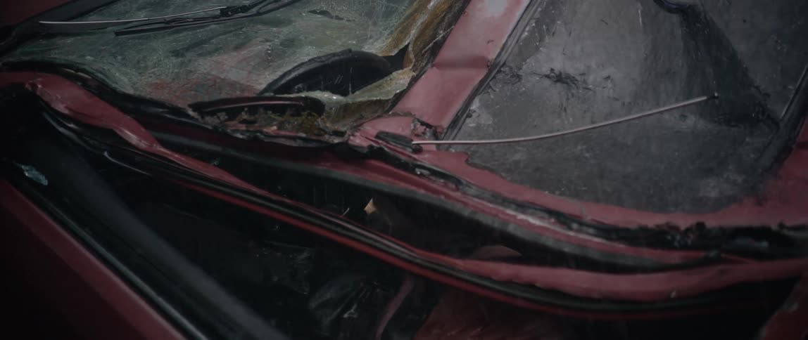 Heavy rain pours on the crushed car