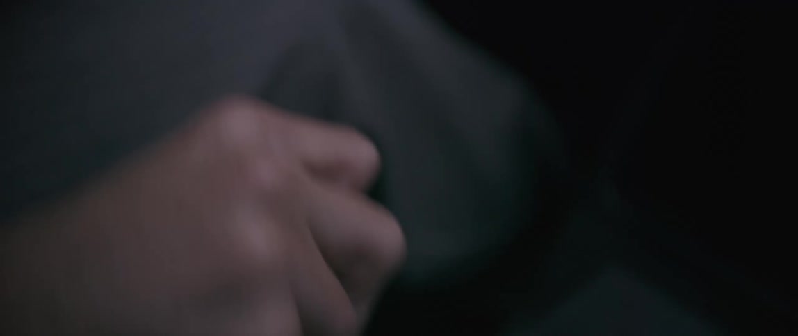 A man uses the gear shift in the car