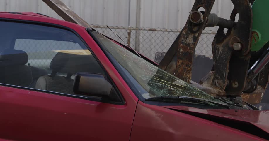 A car is being brushed by an excavator