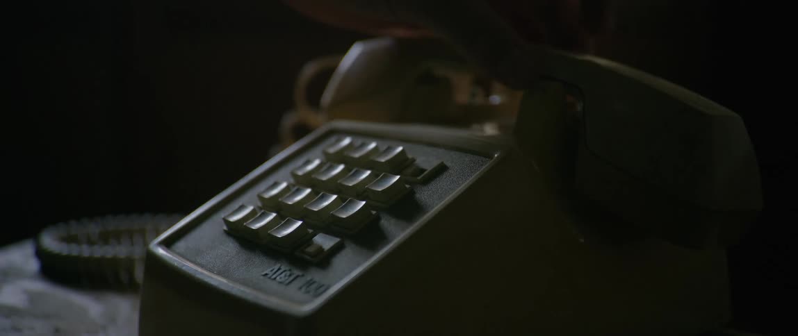 Putting receiver of an old school push button telephone back on its cradle