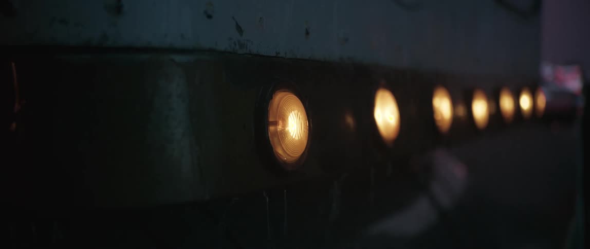 A footage of lamps on during a rainy night