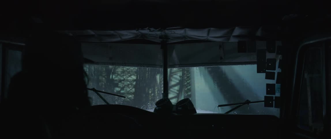 A truck drives over the bridge during heavy rain