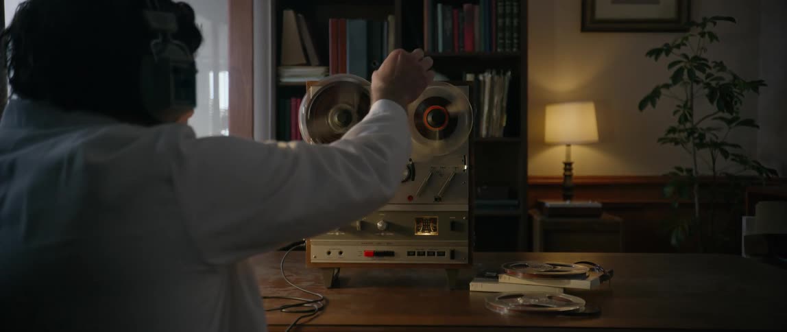 A man turns on his tape recorder