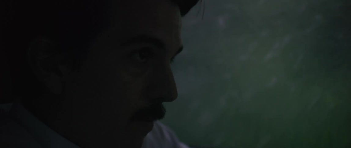 A man driving a vehicle with a focused look