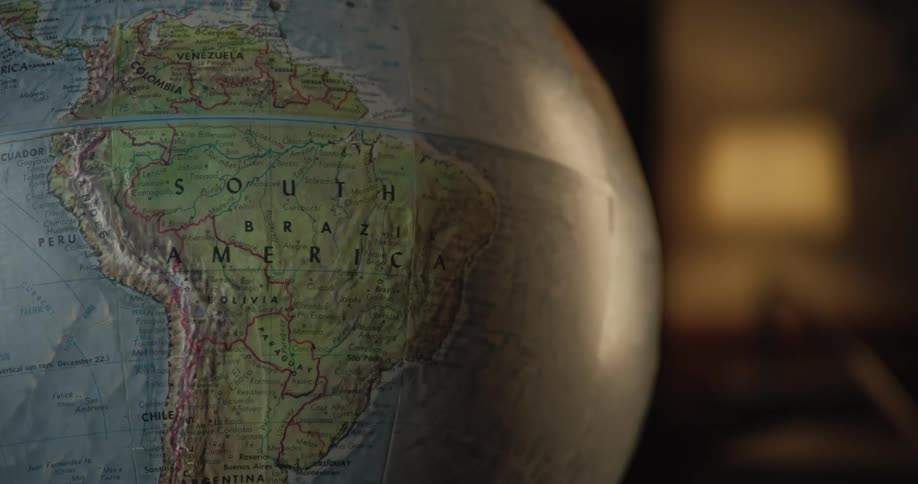 A globe in a room focusing on south america and brazil