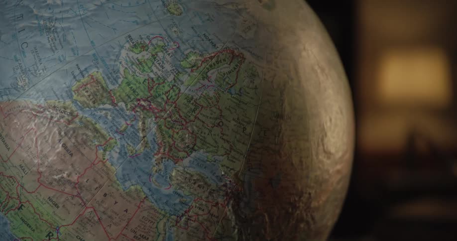 A world globe is in the dark room