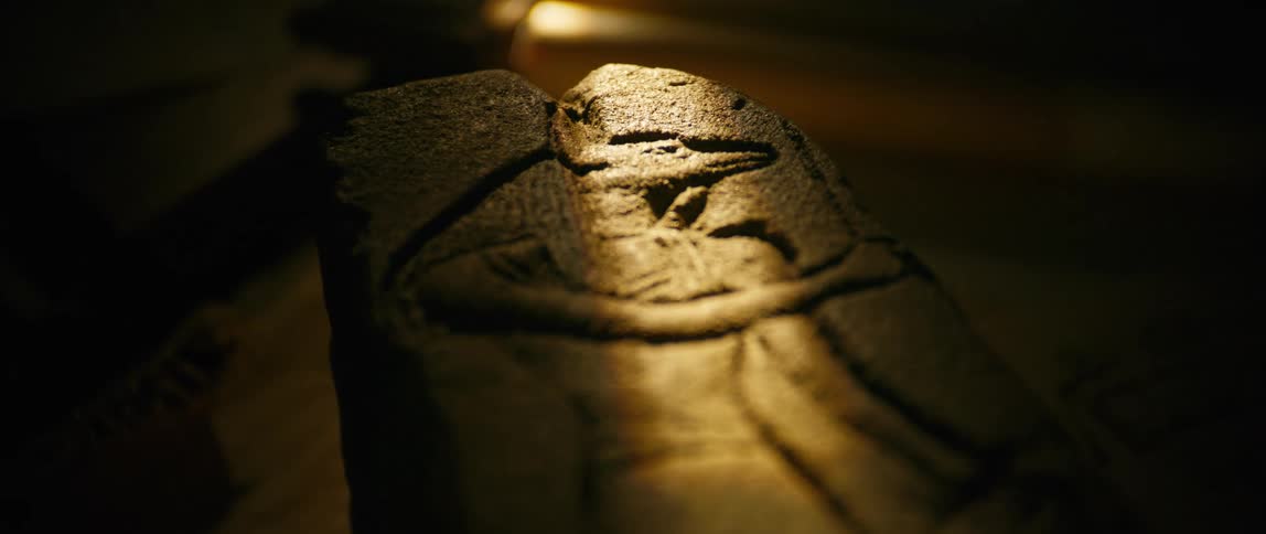 Light falling on a carved stone with the image on anubis on it