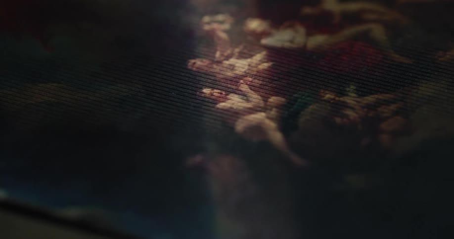 A line of light shines on the painting in the dark