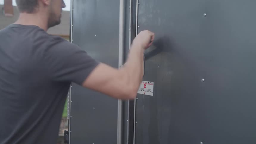 A man opens the doors to his trailer
