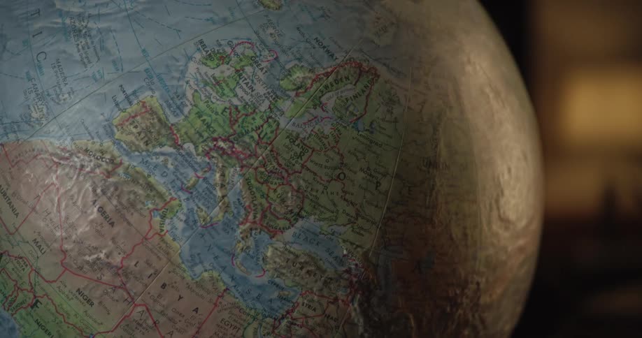 Light shines on the side of a globe of the earth