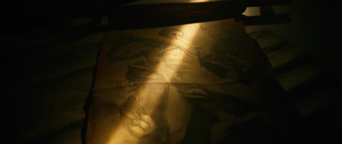 A ray of light lays across the old painting