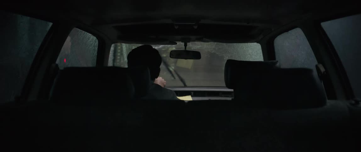 During a rain storm a man is driving his car carefully