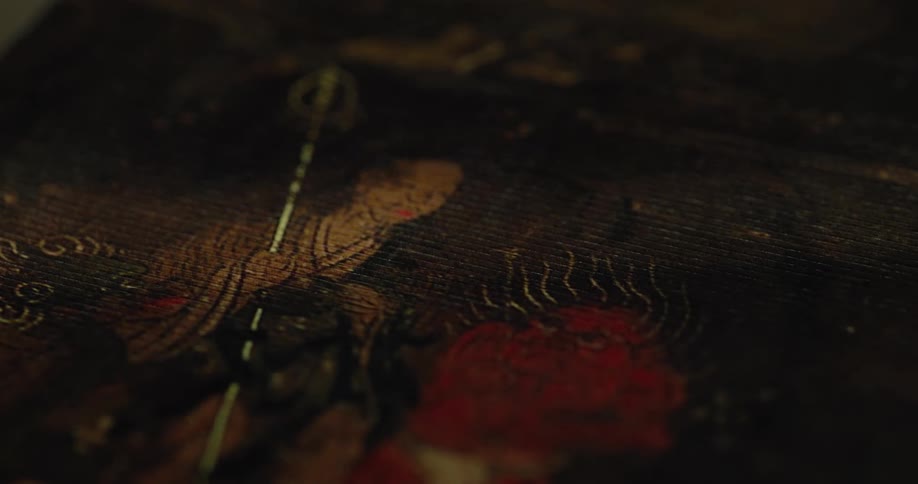 A close up of a painting of a priest and a demon