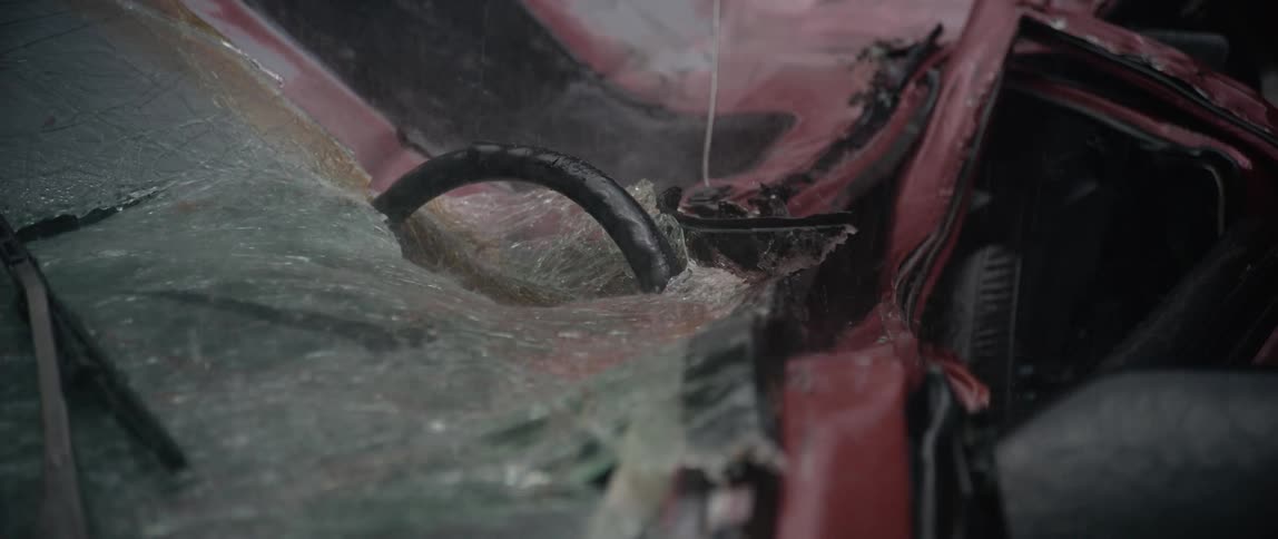 Heavy rain pours on the crushed vehicle
