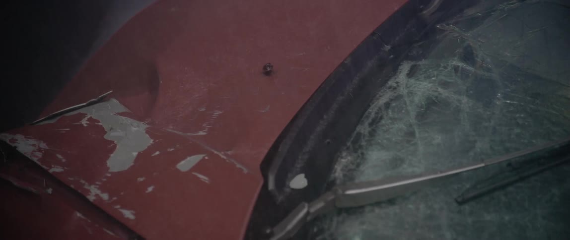 Red car crashed on the road on a rainy day