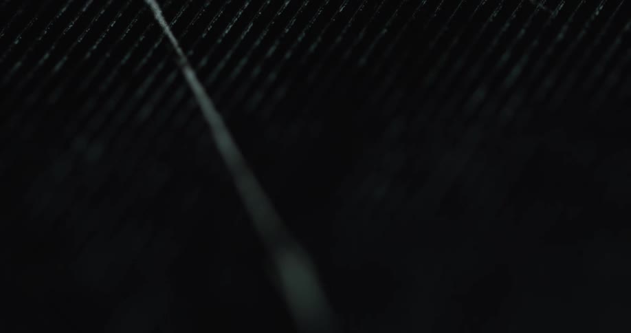 A close up of a black ridged item