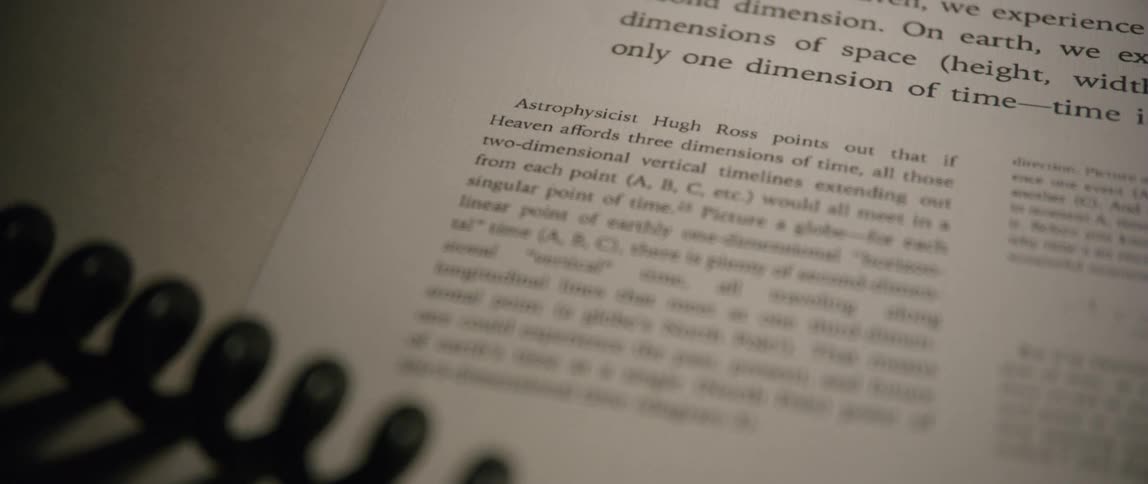 A spiral cord is stretched past a page of text