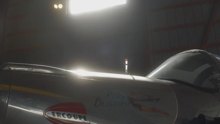 A small aircraft is parked in a hangar