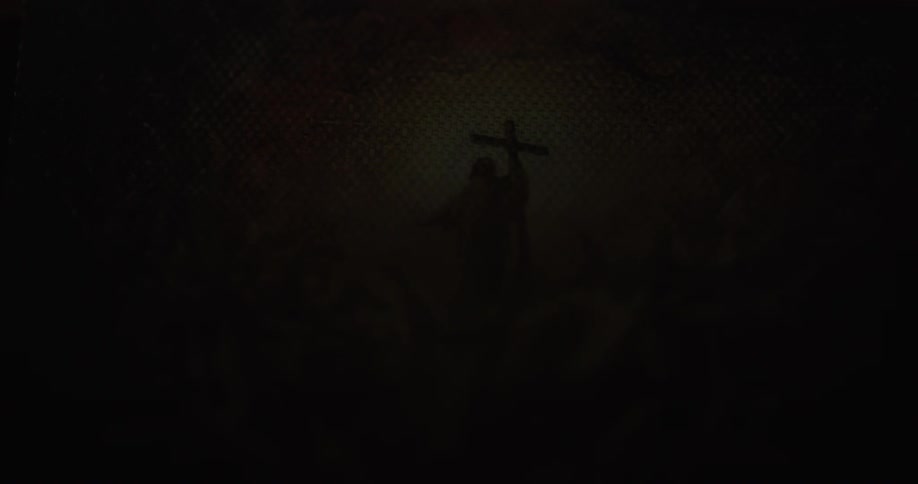 A religious figure holds a cross amid clouds in the sky