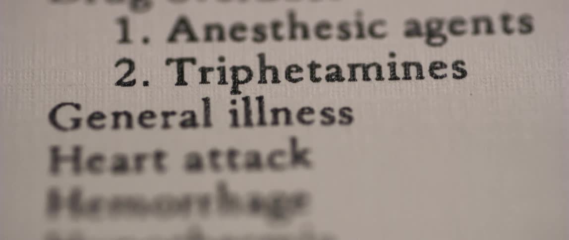 A piece of paper is visible with many different medical terms listed