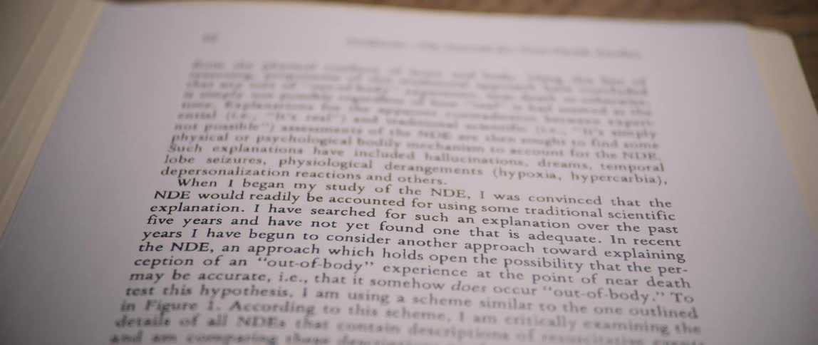 A hand moves a pencil over a printed page placed on top of a document inside an open folder