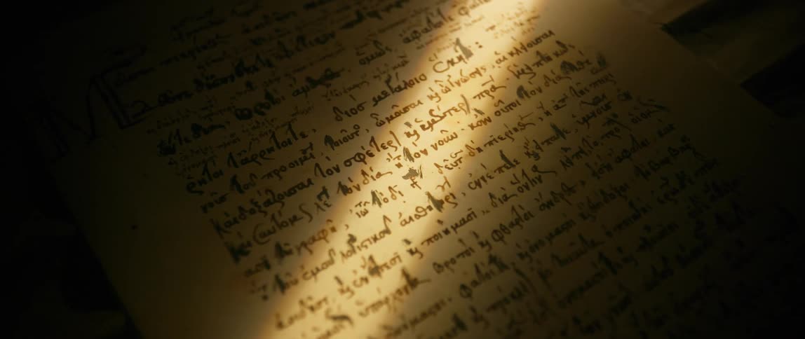 An ancient manuscript on a page under a beam of sunlight