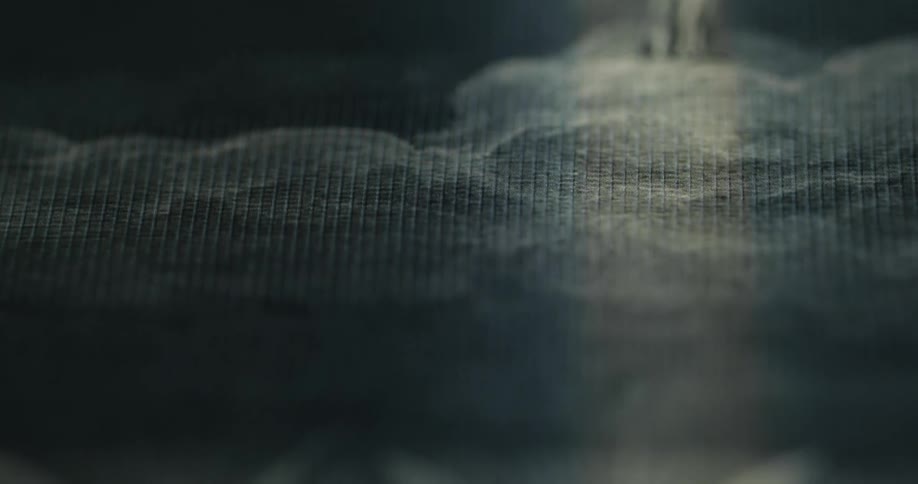 A black and white painting is of people standing on clouds