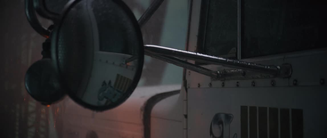 The rain is pouring on the trucks rearview mirror
