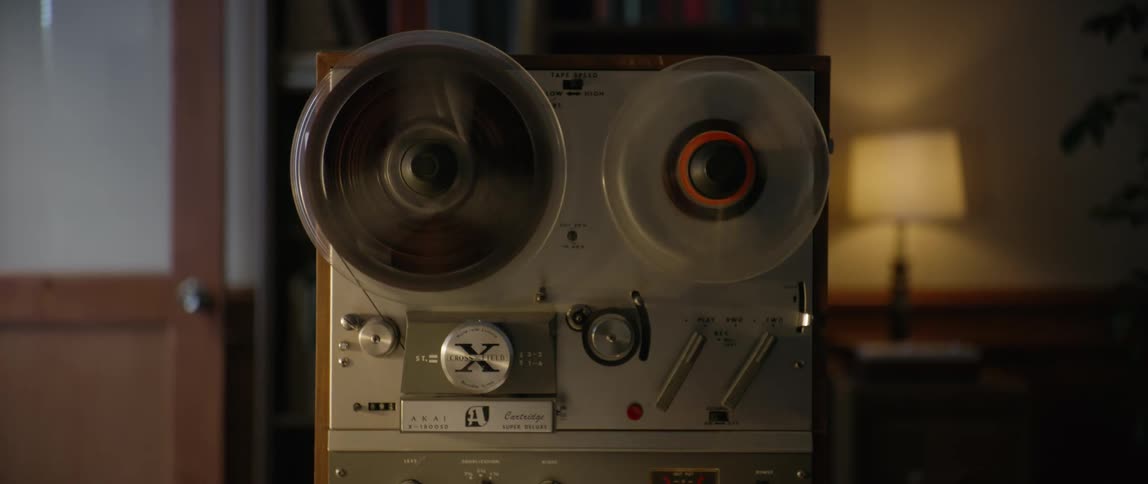 A man loads old movie reals on a movie projector