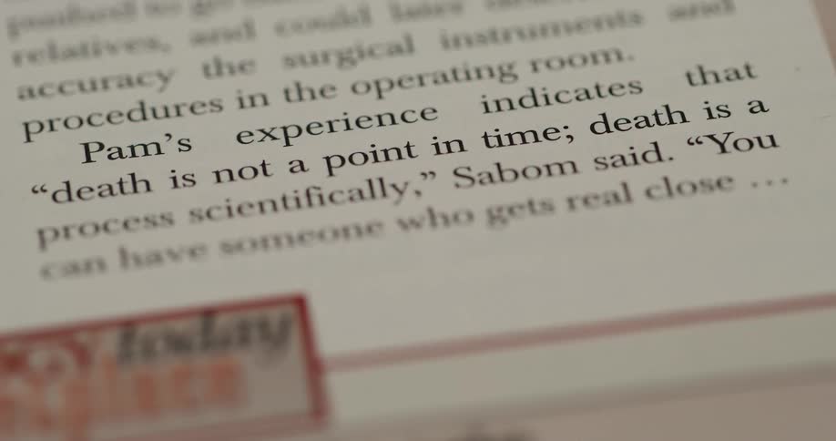 A close up slightly angled shot shows a printed text excerpt from a book