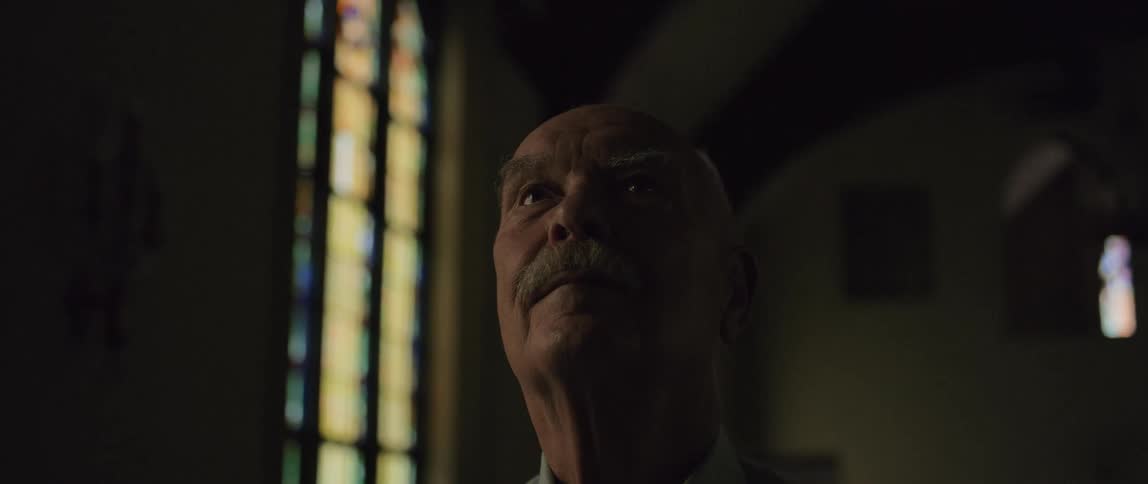 A man looks in awe at the church he stands in