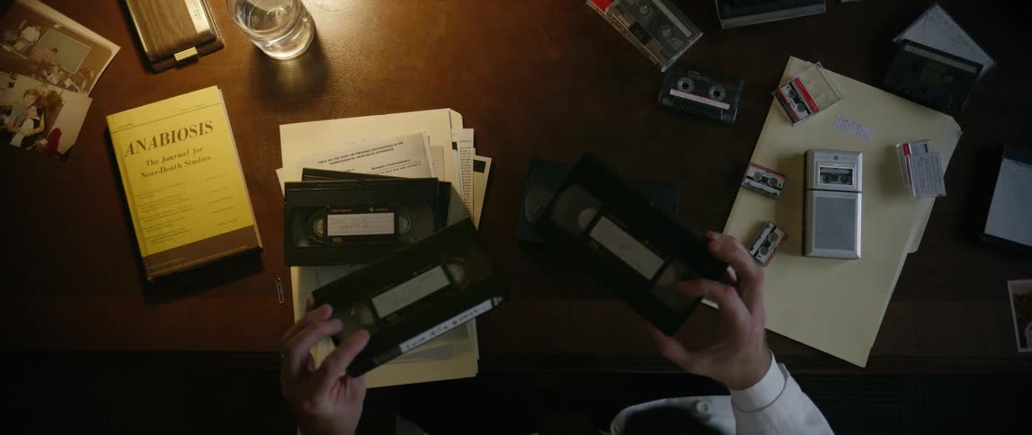 Pair of hands of a person handling old video tapes
