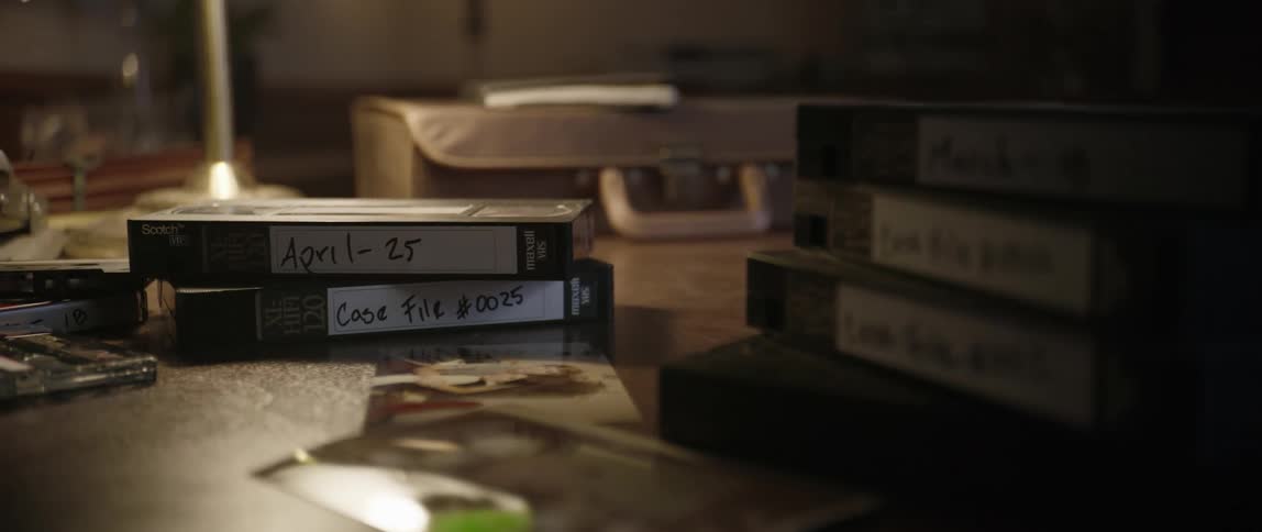 Tapes and photos are on the desk
