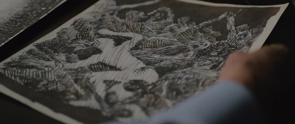 A person looks at a sketch