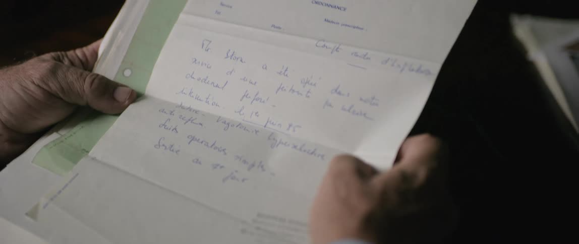 An image of a person holding a document