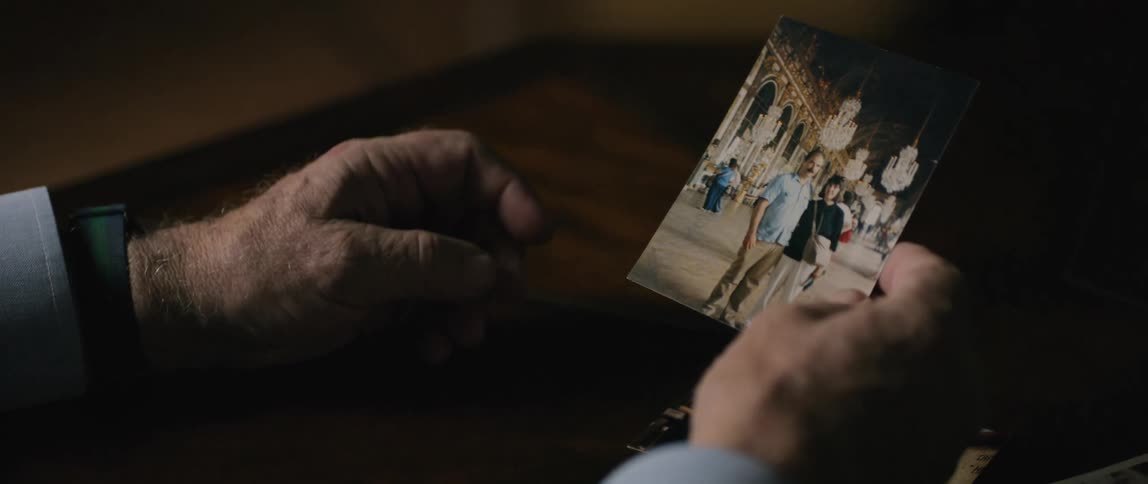 Pair of hands of a person looking at photographs