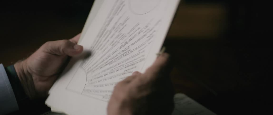 Pair of hands looking at sheets of documents