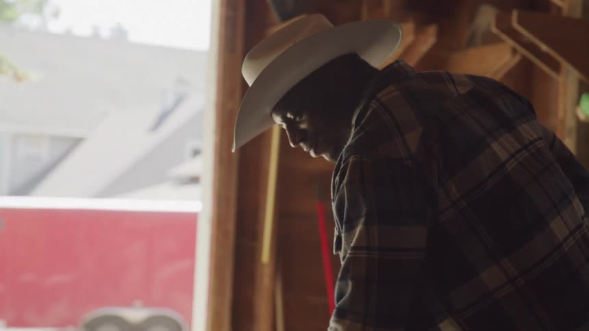 A man is working in the barn