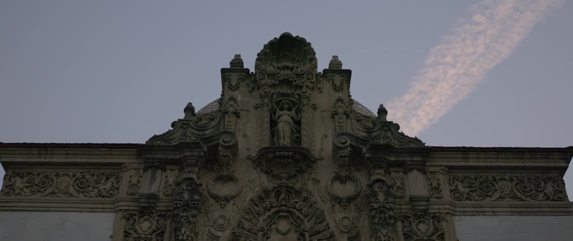 Classic exterior architecture with a statue in the center